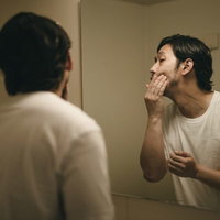 昨日の試合で殴られたあごが痛む無精髭の男性ボクサーの写真