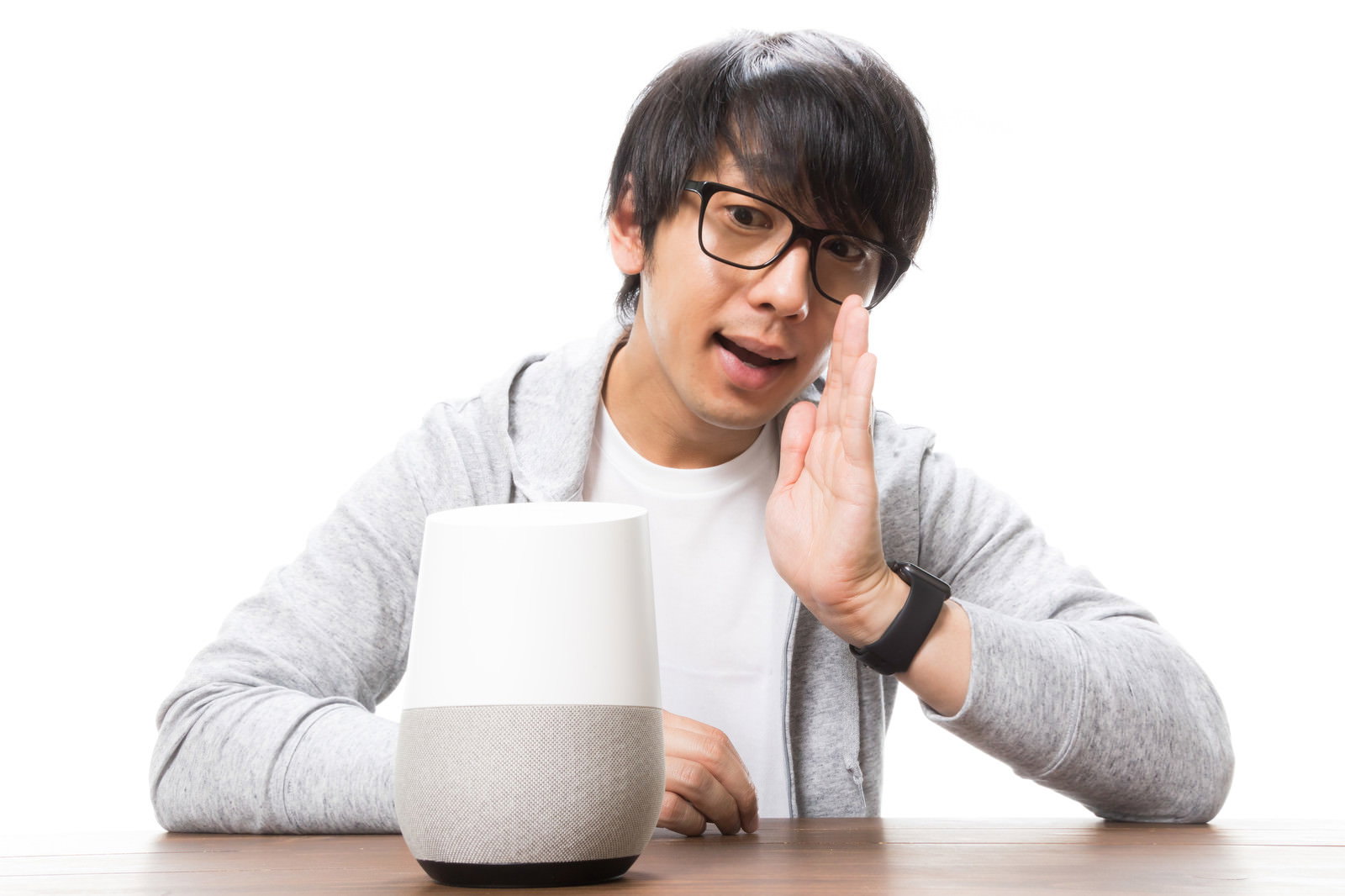 スマートスピーカーに呼びかけるメガネをかけた男性［モデル：大川竜弥］
