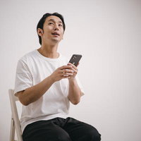 再就職を希望するアラフォー男子がスマホで情報確認の写真