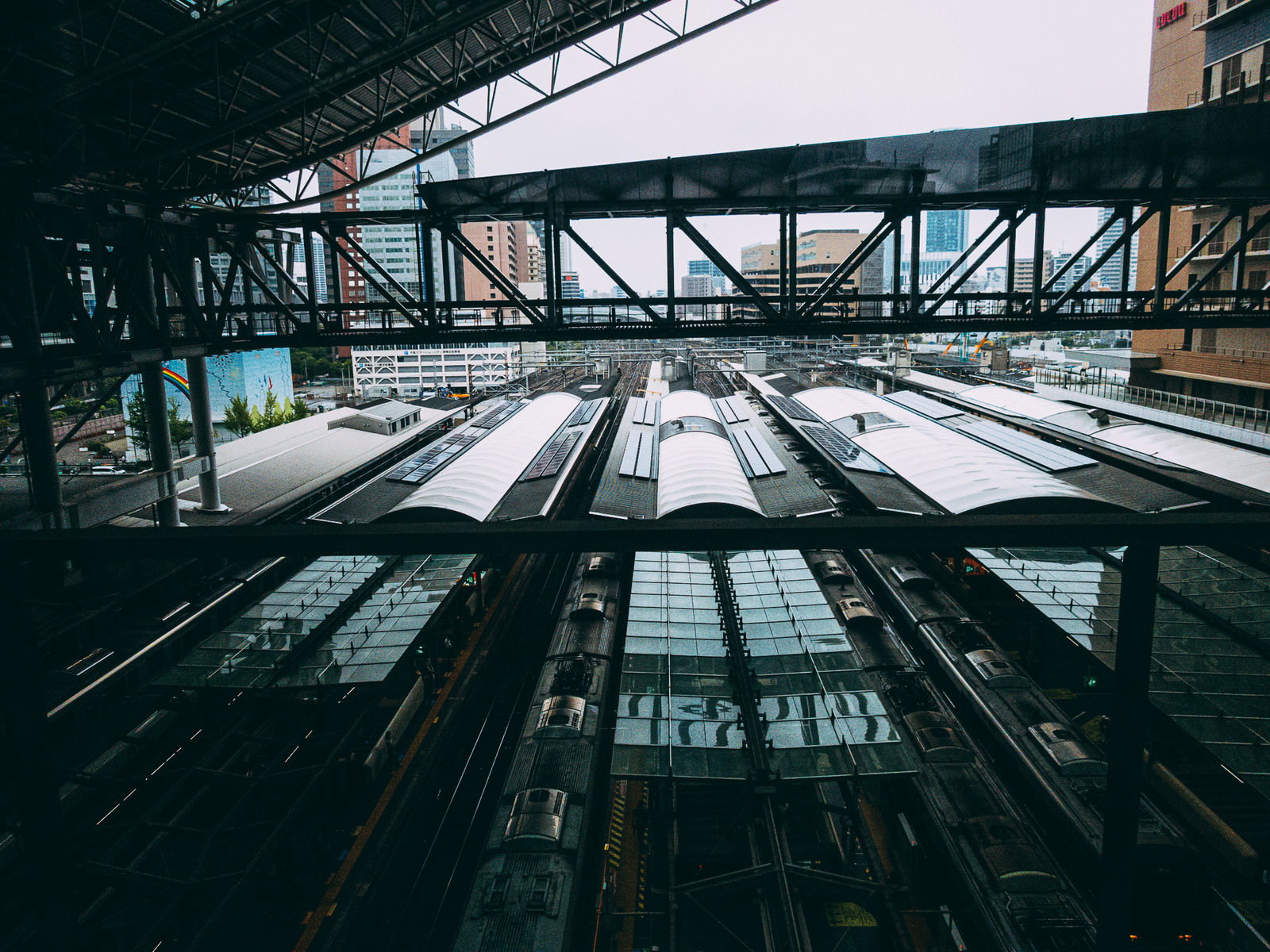 鉄骨構造の屋根の下に複数の線路とホームが見える大阪駅の俯瞰写真