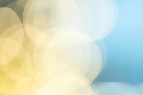 黄色と青のグラデーションに丸ボケが重なる光の表現