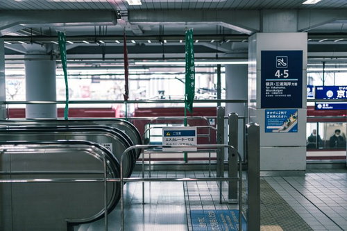 駅構内のエスカレーター前に設置された金属製の手摺り