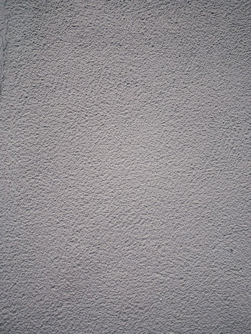 マスチック塗装されたグレーのコンクリート壁のテクスチャー