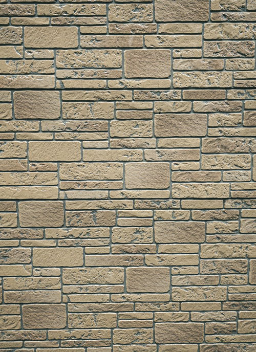 ベージュ色の長方形タイルが規則的に並んだ壁のテクスチャー