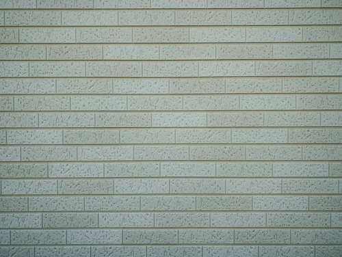 小さな凹模様があるグレーのタイル壁テクスチャー