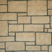 大小不揃いの長方形タイルが敷き詰められた壁面のテクスチャーの写真