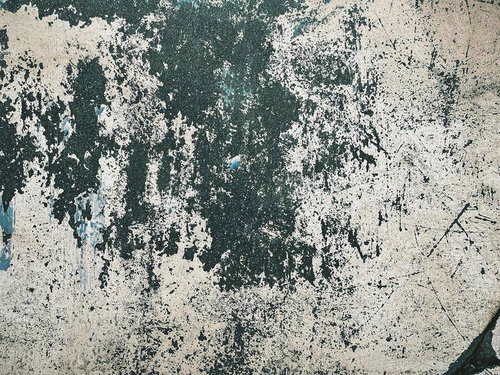 緑色の塗装が剥げた古い壁のテクスチャー