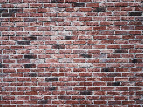 中心が白みを帯びるレンガ壁のテクスチャー