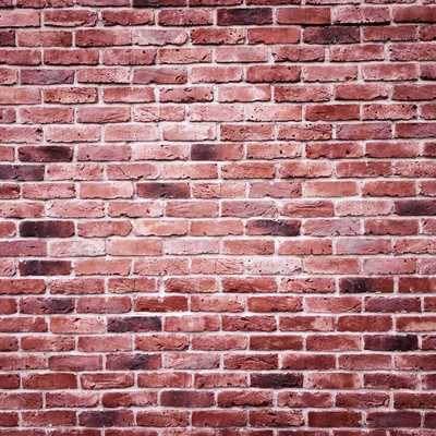 中心部分が白くかすれたレンガ壁のテクスチャーの写真