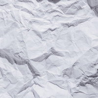 丸めた紙を広げた時のくしゃくしゃなシワと凹凸のテクスチャーの写真