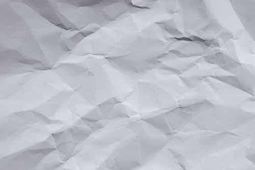くしゃっと丸めてしまった白い紙のテクスチャー
