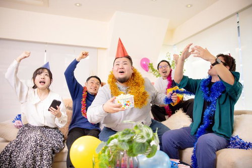 大熱狂するホームパーティー会場で手を上げて盛り上がる皆さん