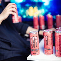 ピンモンの缶に囲まれながら夜間作業するデザイナーの写真