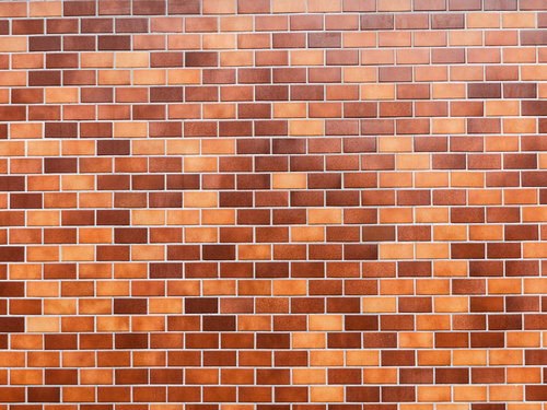 規則的に積まれた茶色いタイル壁のテクスチャー