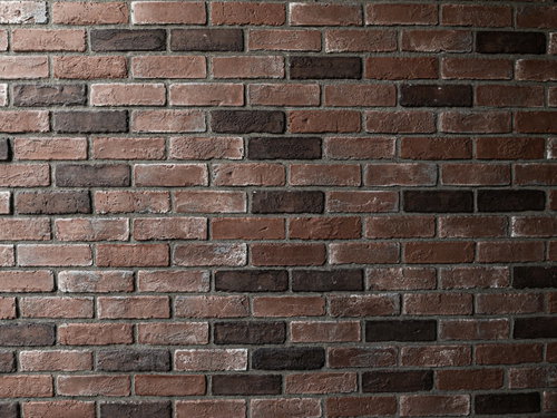 赤茶色に埋め込まれたレンガの壁のテクスチャー