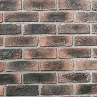 埋め込まれた黒染み煉瓦の壁のテクスチャーの写真