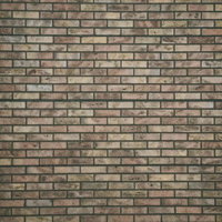 時間の経過を感じさせる薄汚れたレンガ壁のテクスチャーの写真