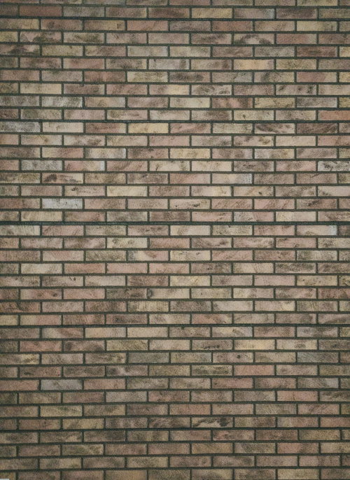 時間の経過を感じさせる薄汚れたレンガ壁のテクスチャー