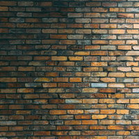 茶色のレンガ壁に右上から当たる照明の光と陰影の写真