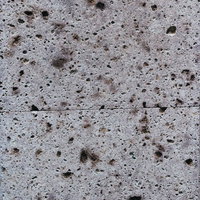 コンクリート壁に残るたばこの焦げ跡とシミの写真