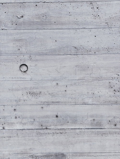 枠板跡とセパ穴の残るコンクリート壁のテクスチャー