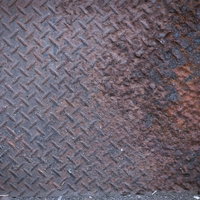 錆びと塗装の剥げがこびり付いた鉄板の劣化テクスチャーの写真