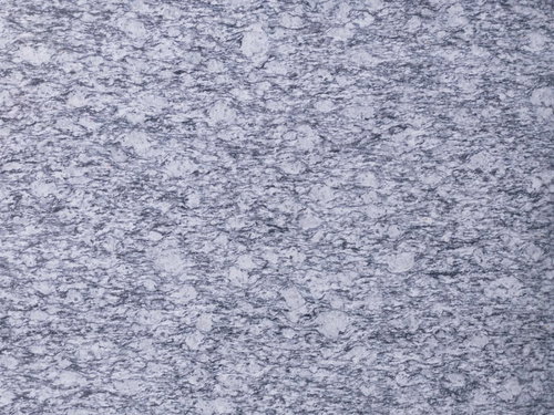 不規則な斑模様が広がるグレーの石材タイル