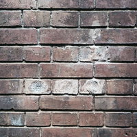 補修跡が見える穴埋めされたレンガ壁のテクスチャの写真