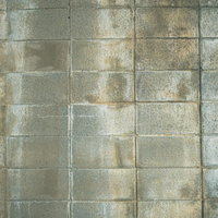 経年劣化した黄ばみ汚れのブロック塀テクスチャの写真