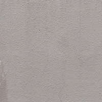 モルタル外壁のクラックから染み出す茶色い汚れのテクスチャーの写真