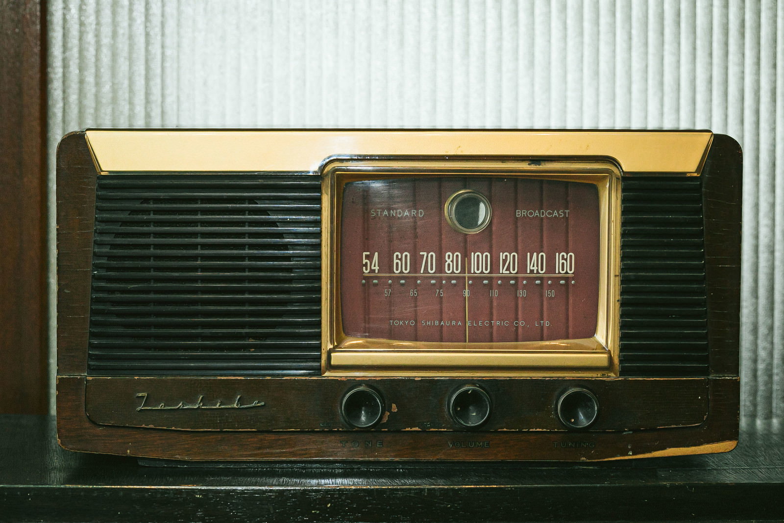 Vintage retro radio with a wooden cabinet and gold accents