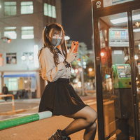 なに見てんのよ晒すわよ、夜の街角で電話ボックス前のマスク美女の写真