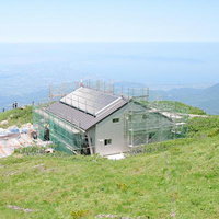 建設中の山小屋と広大な景色が広がる伯耆大山の山頂の写真