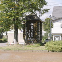 駅前の妙高山登山口の標識と樹木、新潟県の観光地の写真
