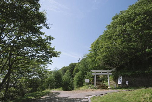 日光男体山四合目の登山口に立つ白い鳥居と参道の風景