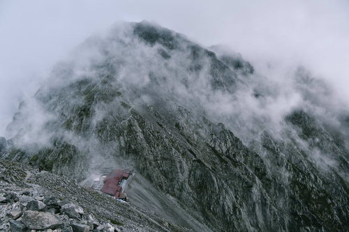 ガスに包まれる穂高岳山荘と奥穂高岳の岩壁