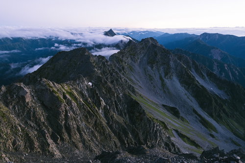 夜明けの奥穂高岳、薄紫の空に浮かぶ岩稜と尾根