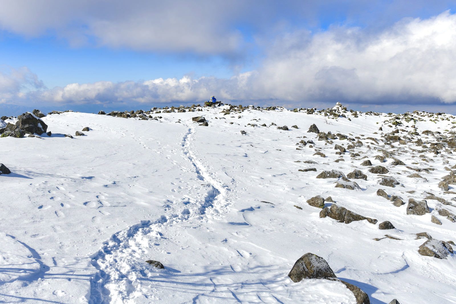 A winter mountain landscape with a single trace on the snowy expanse of Mount Tateshina