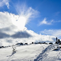 日本百名山・蓼科山の山頂に広がる雪原と太陽の写真