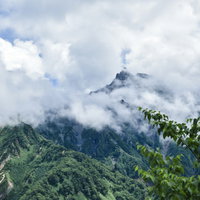 雲に霞む槍ヶ岳山頂を眺める（鷲羽岳）の写真