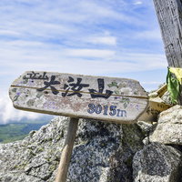 立山の日本百名山・大汝山山頂に立つ木製の山頂標の写真