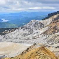 安達太良山の爆裂火口と秋元湖方面を望む山頂からの景観の写真