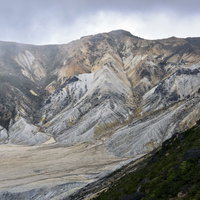 暗い雲に包まれる鉄山方面（安達太良山）の写真