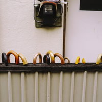 柵につかまるように据えられた溜まる傘の写真