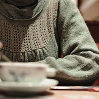 カフェでコーヒーを飲みながら話し合う女性の写真