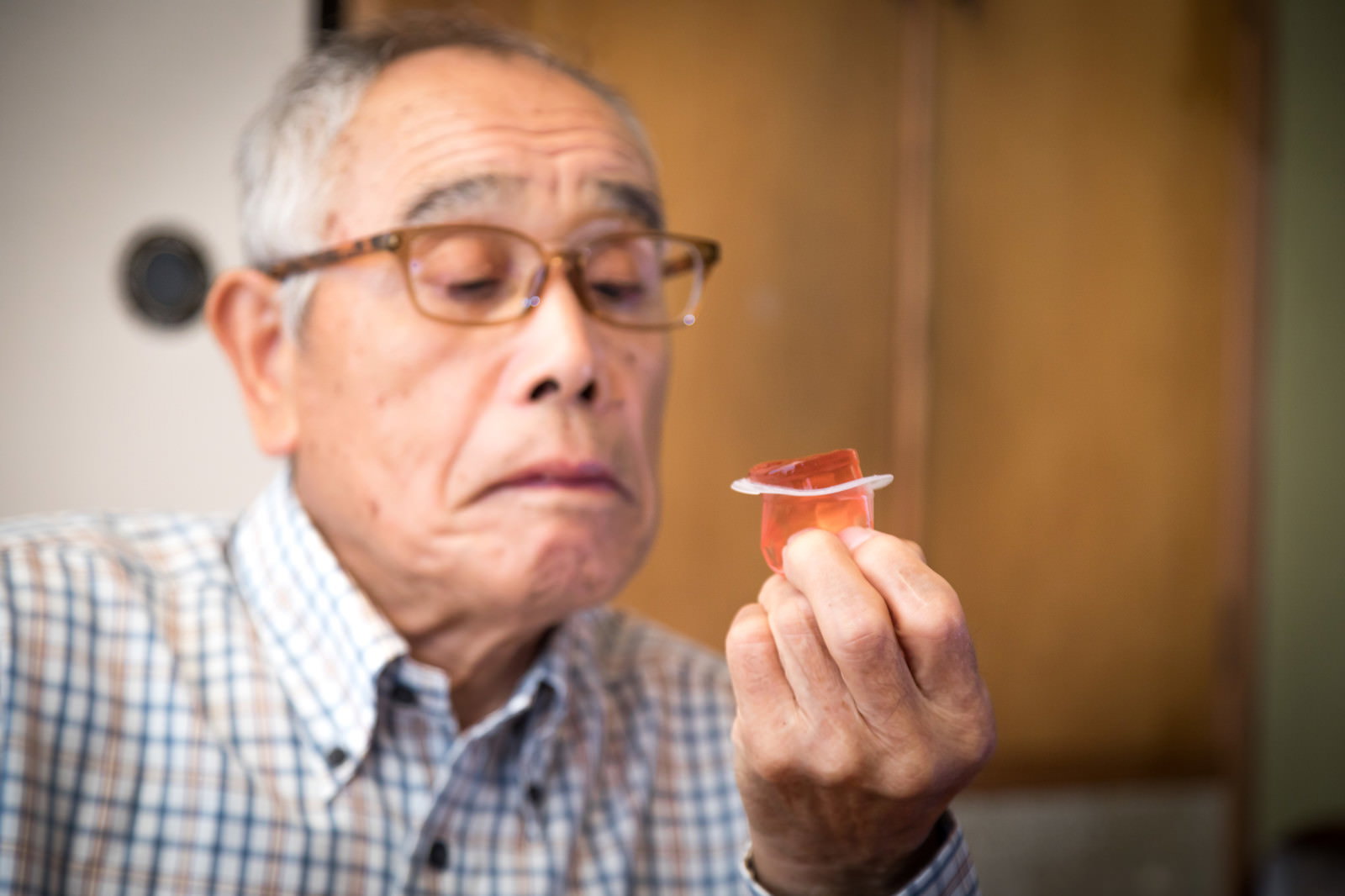 喉に手を当てる高齢男性［モデル：まーちゃん］