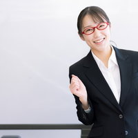 笑顔でガッツポーズをして応援するセミナー講師の写真