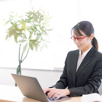 ノートパソコンに入力作業する女性秘書のビジネスの写真