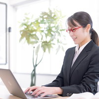 コーディング中の女性エンジニア社員がノートパソコンでプログラミング作業の写真