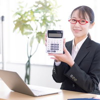 笑顔で電卓の商品説明をする女性社員の写真